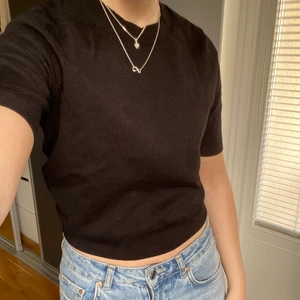 Svart stickad Tshirt  - En svart finstickad Tshirt ifrån Lindex. Tröjan är uppvikt på bilden