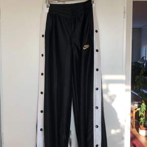 Supersnygga trackpants från Nike! Byxorna har fickor och knappar längs benen som går att öppna. Obetydligt använda, som nya. Inköpspris ca 600kr