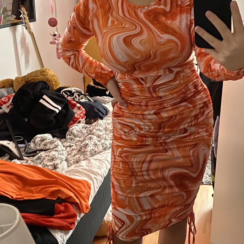 Orange melerad klänning från Shein. Den har dragsnörning på båda sidorna så man kan ha klänningen både lång och kort, det gör man som man vill. Sista bilden är från modellen. Långärmad. Väldigt skönt material!. Klänningar.