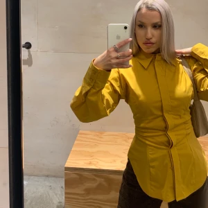 Mustard yellow top - Wonderful shirt that is well-fitted and high quality. No breakage, holes or anything of that nature so it’s a good as new.