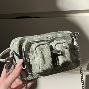 Väska från nunoo - Perfekt utgångs väska från nunoo! Inga defekter💛 grönt ormskinns imitation❤️‍🔥 detaljer med lås & nyckel! Den är liten & bra till fest!  Nypris: runt 1200 kr!