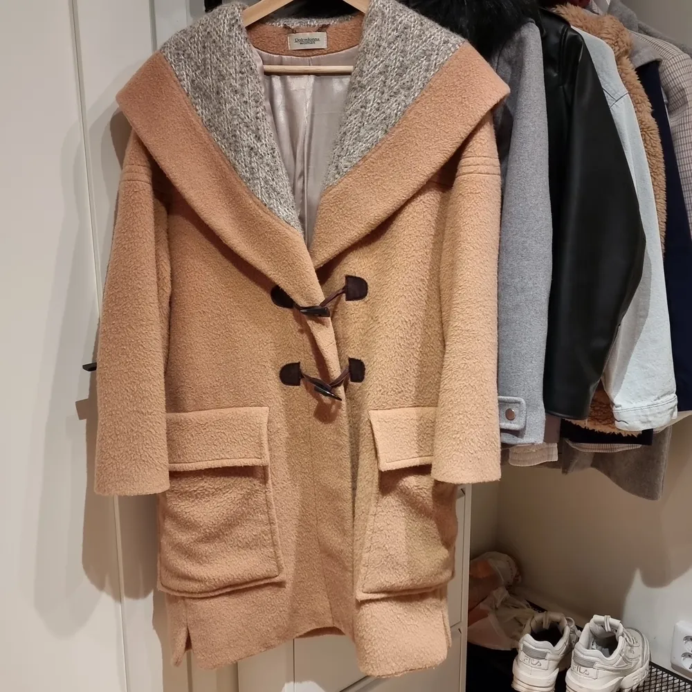 Coat is 100% woolen, in good condition. Suits best for cold weather. Medium length and oversized. If you prefer less oversized fit, it can be seemed as L/XL. Jackor.