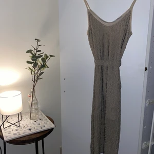 Klänning från Mango  - Klänningen är ifrån mango med storleken S. Beige/vit med svarta ränder. Med ett band i midjan som hjälper att justera hur du vill att klänningen sitter. Använd få gånger så fint skick är den i! Klänningen går strax under knäna som är 172. 