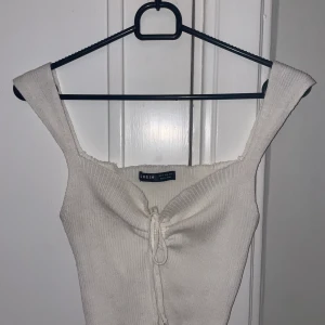 Stickad topp - Stickad vit topp med knytning 