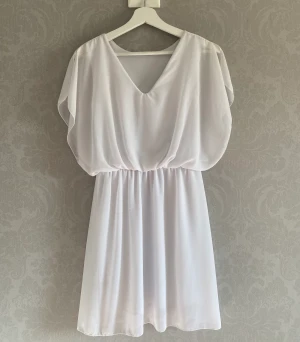 Sommarklänning  - Vit sommarklänning i luftigt material  Storlek: 36/38 Använd 1 gång 