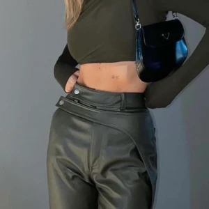 ADSGN Faux Leather Pants gröna  - Faux skinnbyxor från ADSGN. Stl XS men lite oversize så funkar på S också beroende på önskad passform. Mörkgröna. Använda kanske 2-3 gånger men passar inte mig längre tyvärr! Perfekt för höst och utgång!! Nypris 999kr