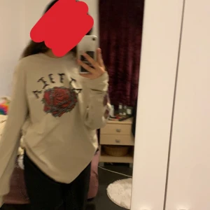 Tröja i storlek 2XL - En tröja med ett coolt tryck av rosor och en text. På armarna finns det ett tryck av rosor också. Den är i storlek 2XL. Priset kan diskuteras. Köparen står för frakten.