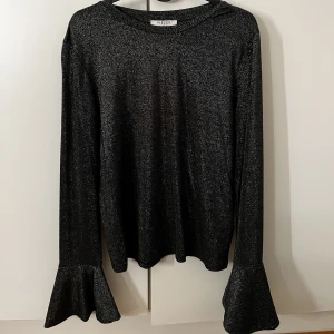 Topp - Glittertopp använd 1 gång. 