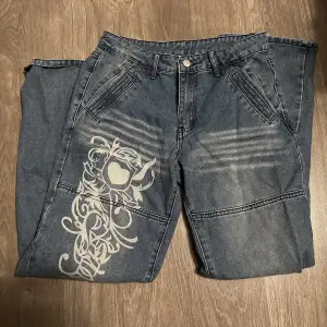 Lågmidjade Jeans med ett fint tryck på högra benet, säljer pga rensar garderoben! 