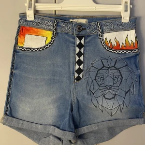 Jeanshorts med måleri - Jeansshorts från ginatricot i storlek 38 men är ganska små så passar 36 också. Fake fickor fram. Egen målat med textil färg och pennor. 