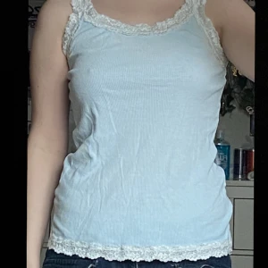 ljusblå spets linne - jättegulligt linne som egentligen va vitt tills de gick lite snett i tvätten, köpt secondhand, storlek M, jättegulligt till sommaren
