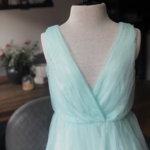 Mintgrön/blå klänning  - Uppklädd klänning i mintgrön/himmelsblå färg storlek 34.  Mått på docka  Byst: 76  Midja: 66cm Stuss: 96 cm   För fler bilder eller frågor kring frakt är det bara att skicka iväg ett PM. 📦📸 