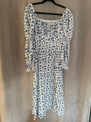 Klänning - Sommarklänning i tunt material med slits nedtill. Medellång. Aldrig använd.