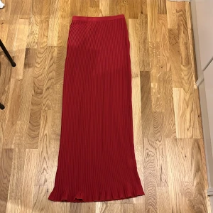 Röd långkjol - Röd långkjol i väldigt fin material. Använd enstaka gånger.