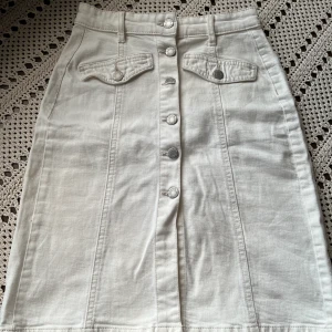 Vit jeanskjol storlek XS - Fin lite längre jeanskjol med slits där framme. Storlek XS, använd ett fåtal gånger!  Kan mötas upp i Stockholm(Kungsholmen ellee Alvik).  