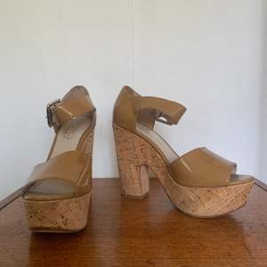 Beige patent leather platform sandals with cork heels. Brand: Kors Michael Kors. Size 38. Used but in very good condition.