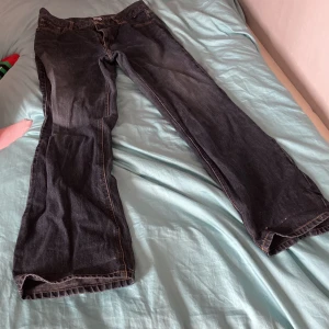 Grå mörk blåa jeans - Grå blå jeans med säkerhets nålar i ena bakfickan