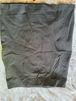 Svart enkel kortkjol från H&M - En svart, enkel och rak kortkjol från H&M i mjukt bomullsmaterial. Kjolen har en clean look utan detaljer och passar perfekt till både vardagsoutfits och mer uppklädda stilar. Superskön och lätt att matcha med olika toppar.