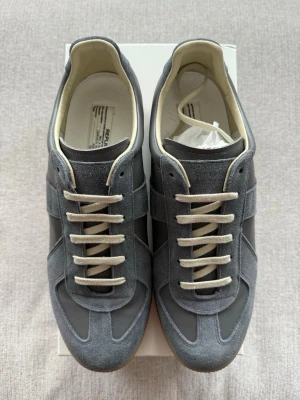 Maison margiela gats (Gray/44) - Great condition margiela gats, never worn. Completely new. Box is damaged! Comes with box and dustbags (everything included in the picture). Same day shipping. Size 44 but fits size 45. Price is negotiable but to a reasonable extent.