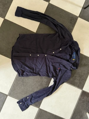 Ralph Lauren skjorta - Fräsch Ralph lauren skjorta i marinblå, använd 2 gånger, som ny. Schysst till vår och sommar.