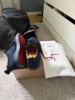 Christian Louboutin low trainers - Snygga mörkblå sneakers i mocka med rödsula. Box och påse tillkommer. Inte använda så mycket men sulorna har tecken på lite användning samt några ställen på mockan. 