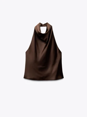 Brun silkes halterneck - Brun sprillansny halterneck ifrån Zara, säljer för att den inte passade mig som den skulle, en liten knapp saknas men det går enkelt att lösa, därav priset. Skriv om ni vill ha fler bilder, har några frågor eller är intresserade 💞