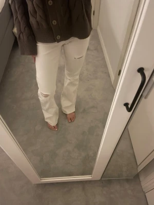 Vita jeans med slitningar - Säljer ett par vita jeans med trendiga slitningar vid knä och lår. Så så snygga, jeansen är i storlek 170 men passar xs och s också. Det har några defekter längst ner då jag trampat på det men annars bra i skick!💓