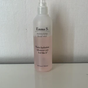 Emma S. moisturising facial mist - Återfuktande face mist från Emma S. i en genomskinlig plastflaska med rosa vätska. Perfekt för att fräscha upp huden under dagen och ge extra fukt. Enkel sprayfunktion och stilren design med svart text på flaskan.