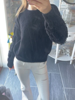 Svart stickad tröja - En svart lite tjockare stickad tröja med annorlunda armar! Står ingen storlek men skulle upskatta som S/M.