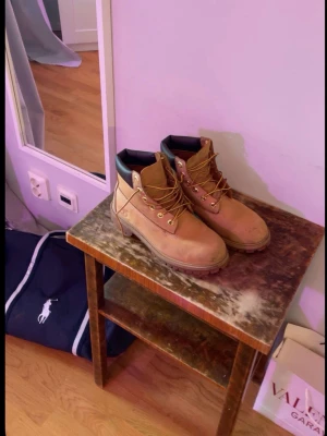 Beige Timberland kängor i mocka!! - Säljer mina Tiberlandkängor som blivit för små. Dom har några slitage vid tån men är varma, snygga och perfekta för vårvädret!!🔥 Hör av er vid frågor👊🔥