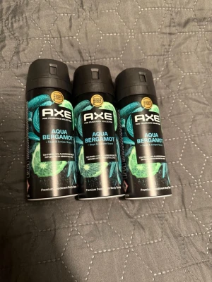 Axe Aqua Bergamot Deospray 3-pack - premium  Tre stycken Axe Aqua Bergamot deosprayer med doft av salvia och enbär. Svarta flaskor med turkosa och gröna detaljer. Praktisk sprayflaska i metall, perfekt för dig som vill ha en fräsch och maskulin doft.