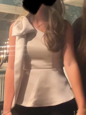 Vit oneshoulder topp med stor rosett - Jättefin festlig topp från HM. Endast använd en gång🤗