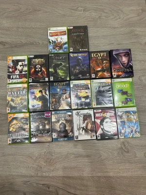 Samling av Xbox 360 och PC-spel 50KR ST! Alla for 900kr - Säljer en samling med Xbox 360- och PC-spel, inklusive titlar som FIFA 07, Star Wars Knights of the Old Republic II, Thief: Deadly Shadows, Egypt II, Battlefield 2 Modern Combat, Just Cause och Rayman. Omslagen är färgglada och spelen kommer i plastfodral.   50KR ST!!!!!!!!!! Allt for 900kr