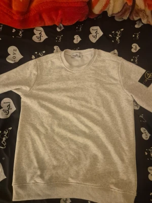 Vit sweatshirt - Vit sweatshirt med klassisk rund hals och ribbade muddar. Tröjan har lång är Materialet är mjukt och känns som bomull, perfekt för chill dagar. Kommer i påse.