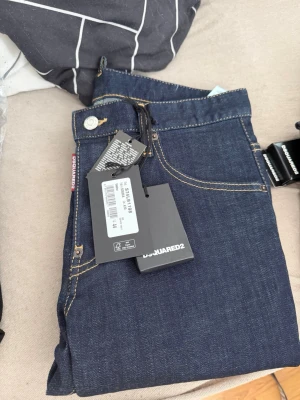 Mörkblå DSQUARED2 jeans - Snygga mörkblå denim jeans från DSQUARED2 strl 44.   Helt nya med kvitto, nypris 3090kr