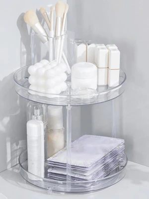 Rund sminkförvaringshylla i akryl. Orginazer  - Snygg och praktisk rund sminkförvaringshylla i genomskinlig akryl. Perfekt för att organisera borstar, bomullspads, flaskor och andra skönhetsprodukter. Två våningar ger gott om plats och den stilrena designen passar alla badrum eller sminkbord. Den e lite skadade men de e it alls fsrlgt