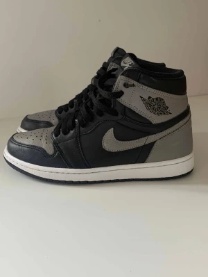 Nike Air Jordan 1 Shadow High - Säljer ett par Nike Air Jordan 1 High i färgen Shadow. De är använda flitigt, men syns bara på nära håll. Allt följes med såsom box och extra snören. Pris kan diskuteras. Skickas samma dag. Bara att höra av er vid funderingar.
