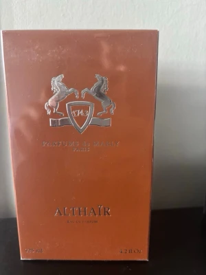 Parfums de Marly Althaïr EdP 125ml - Althaïr Eau de Parfum från Parfums de Marly i en elegant kopparfärgad förpackning med silverdetaljer och logotyp med två hästar. Flaskan rymmer 125 ml och doften är exklusiv och lyxig, perfekt för dig som vill sticka ut.