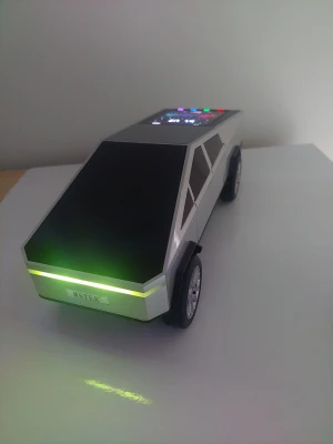 WSTER WS-580 Bluetooth-högtalare i Cybertruck-design med LED-skärm - WSTER WS-580 är en Bluetooth-högtalare designad som en Cybertruck. Den har en stor LED-färgskärm och LED-belysning. Högtalaren har Bluetooth-funktion, FM-radio, TF-kort/USB-ingång och handsfree-funktion. Den har även TWS-funktion för att koppla ihop två högtalare. Batteriet är uppladdningsbart med en kapacitet på 2400mAh och ger en speltid på 3-5 timmar. Uteffekten är 15 Watt RMS. Måtten är 297mm x 114mm x 109mm.
