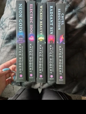 Dark Olympus Series by Katee Robert  - The first 6 books in the Dark Olympus series by Katee Robert  Neon Gods Electric Idol Wicked Beauty  Radient Sin Cruel Seduction. All of them are unread, just lived on the shelves. These are the original covers that is out of print.  I pack good and ship fast🤗 Cats in the home🐈  #kateerobert #darkolympus #darkolympusserie #kateerobertneongods #kateerobertbooks #kateerobertelectricidol #neongods #electricidol #wickedbeauty #radientsin #cruelseduction #midnigtruin #outofprint #outofp