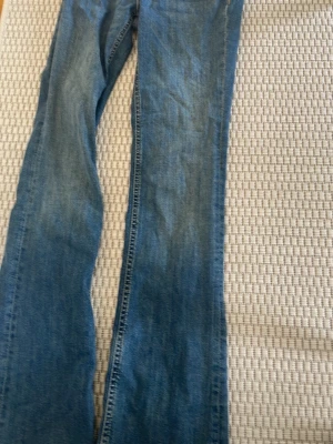 Blå jeans från Zara bootcut - Snygga blå bootcut jeans från Zara med klassisk femficksdesign och normalhög midja. Jeansen är tillverkade i denim och har en lätt tvättad look som passar perfekt till många olika stilar.