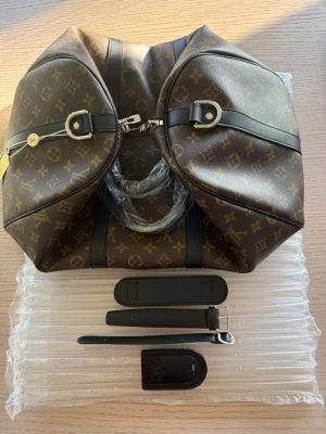 Louis Vuitton Keepall 45 - Ny och oanvänd. Längd: 45 cm Höjd: 27 cm Bredd: 20 cm. Avtagbar axelrem saknas. 