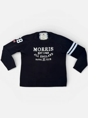 Marinblå tröja från Morris - Svart tröja från Morris med vitt tryck på bröstet, texten 'Morris EST 1968 All England Naval Club'. Två vita ränder på ena ärmen och siffran 98 med brittisk flagga på andra. Rund hals och ribbade muddar.