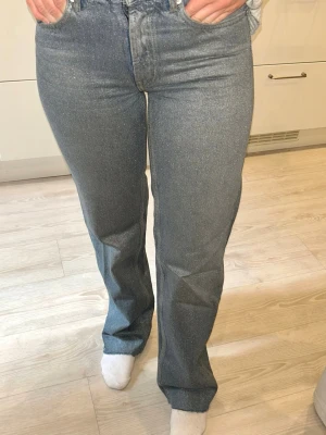 Glittriga raka jeans med hög midja - Säljer ett par blå glittriga/skimriga jeans, använda fåtal gånger. I modellen Sia från Lindex.