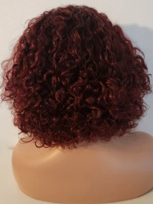 100% human hair, äkta hår curly wig with Fringe, Vinröd lockig peruk med lugg - Snygg vinröd peruk med kort, lockigt hår och lugg. Peruken har en naturlig volym och glans, perfekt för att ge din look en extra edge. Tillverkad av 100% human hair, äkta hår material som är lätt att styla och bära.