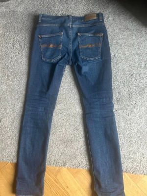 Blå slim jeans från Nudie Jeans - Nudie Jeans grim tim storlek W31 L34, sparsamt använda - mycket bra skick