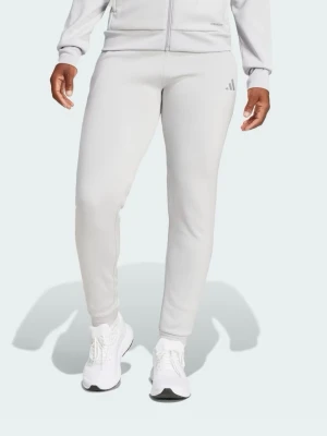 Nya ljusgrå mjukisbyxor från Adidas - Snygga ljusgrå mjukisbyxor från Adidas med smal passform och diskret logga på ena benet. Byxorna har fickor på sidorna och är tillverkade i ett mjukt och stretchigt material som är perfekt för chill eller träning. Helt nya.