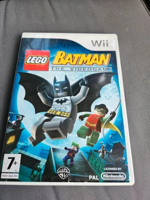 LEGO Batman The Videogame Wii - LEGO Batman The Videogame till Nintendo Wii. Omslaget är blått med LEGO-versioner av Batman och Robin i fokus. Spelet är licensierat av Nintendo och Warner Bros och har PEGI 7+. Perfekt för dig som gillar action och äventyr i LEGO-format.