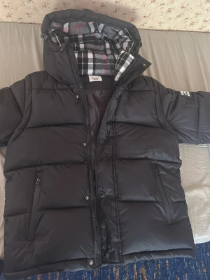 Burberry pufferjacka - En svart snygg puffig vinter jacka som håller dig varm i kallt väder. Är bra för alla årsitder också eftersom den går o göra en väst. Den är helt ny. Inget fel med den. Och har vattentäta fickorgår att diskutera pris privat