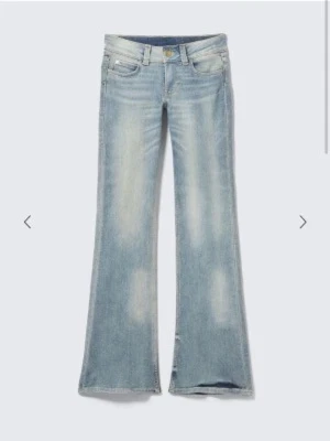 Ljusblå cheap monday jeans - Säljer ett par ljusblå bootcut jeans med snygga slitningar och utsvängda ben. Jeansen har klassisk femficksdesign och låg midja. Perfekta för en avslappnad och trendig look.